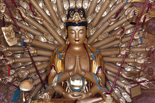 Buddhist deity statue with many arms