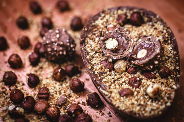 Chocolate egg with filling for Easter on wooden background