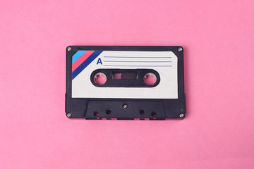 Audio retro vintage cassette tape 80s style on pink background