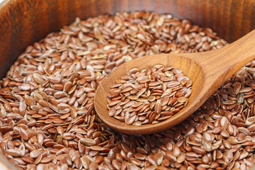 Brown flax seed in bowl and spoon.