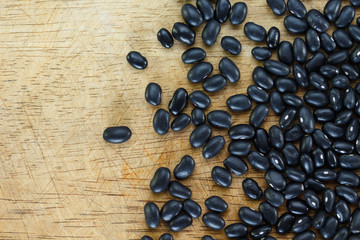 Heap Black bean on wooden background.
