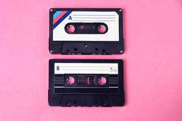 group of two audio retro vintage cassette tape 80s style on pink background