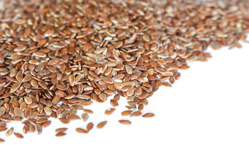 Brown flax seed on white background.