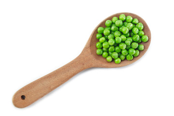 green peas on wooden spoon on white background.