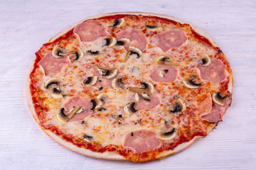 Pizza with a carbonate and champignons with tomato sauce