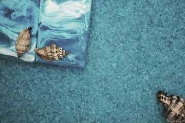 handmade soap and seashells on the background of sea salt