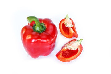 red bell pepper cut into pieces on white background, top view.