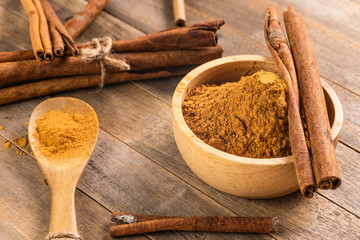 close-up of cinnamon powder in bowl on wooden table
