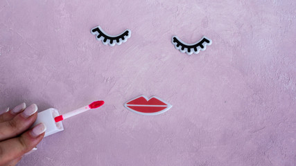 Creative woman face made of eyelashes, and lips. Minimal beauty concept. Pink background, fashion flat. banner