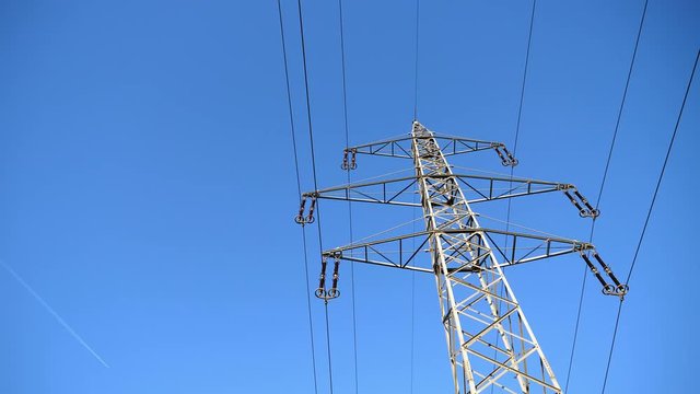 High Voltage Steel Lattice Pylon Against Blue Sky