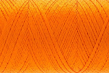 Macro picture of thread texture orange color background