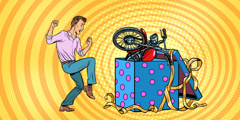 Man and motorcycle holiday gift box, funny reaction joy.