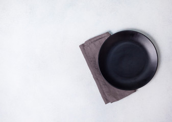 black plate and linen napkin