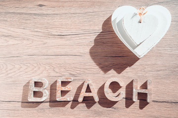 Summer Bacground With Beach Accessories On Wooden Board. White heart.