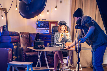 Vlog. Studio for shooting video. The operator adjusts the video camera. Video review. A man smashes video cameras for shooting a video blog.