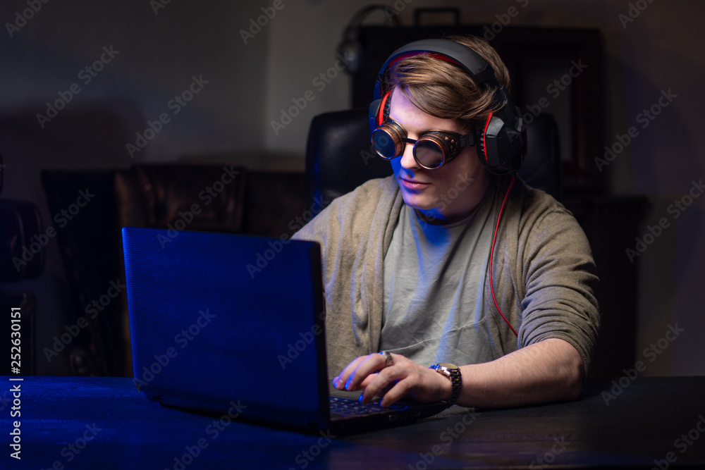 Poster hacker. a man at the computer. hacking personal data. a man with glasses.