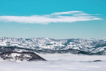 Fototapeta na wymiar snow mountain landscape with fog and blue sky. 