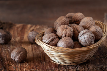Whole walnuts on a rustic old wooden table