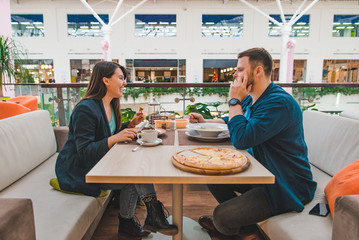 couple having lunch in mall cafe together. date talking