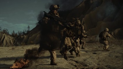 Armed Soldiers Being Attacked and Bombed During Combat Mission in the Desert Region. Heroic Action of Brave Soldiers in the Face of Deadly Danger. Soldiers Saving Wounded Comrade under Enemy Fire