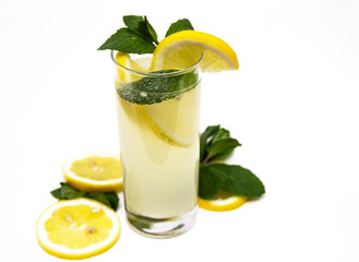 a glass of fresh lemonade, against a background of lemons and mint, isolated on a white background.