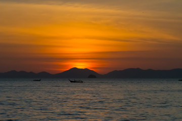 Plakat sunset over the mountains in thailand sea