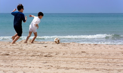 Children playing with a ball on the beach