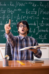 Funny male math teacher in the classroom 