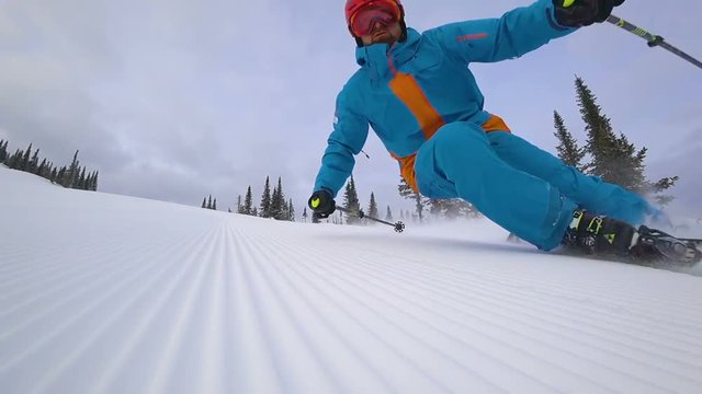 skier makes a turn on the ski track. lie down in turn touching the snow. at the fresh velvet from snowgroomers. ski carving. super slow video. the edges of the snow from the groomer. video footage