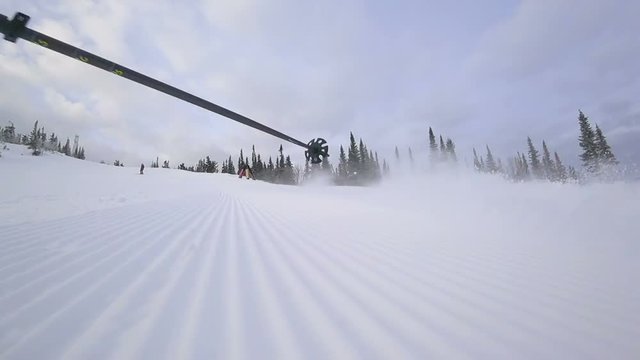 skier makes a turn on the ski track. lie down in turn touching the snow. at the fresh velvet from snowgroomers. ski carving. super slow video. the edges of the snow from the groomer. video footage