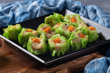 close up of steamed pork dumplings on plate
