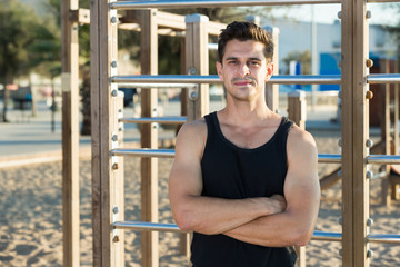 Man in sportswear near fitness station