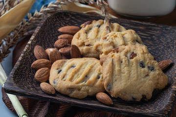 close up of almond cookies on wooden plate