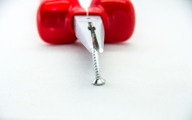 red pliers with a screw on a white background