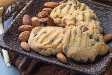 close up of almond cookies on wooden plate