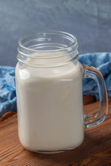 close up glass of milk on wooden table