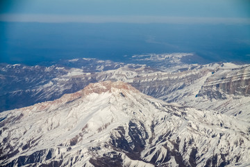 view from the plane window to the Caucasus mountains