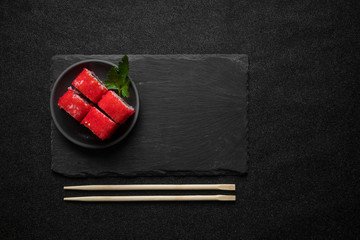 Sushi rolls, maki, nigiri on black stone slate on dark background copy space © sutulastock
