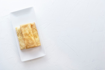 Chinese tortillas - bings in a plate on a white background.View from above. Copy space