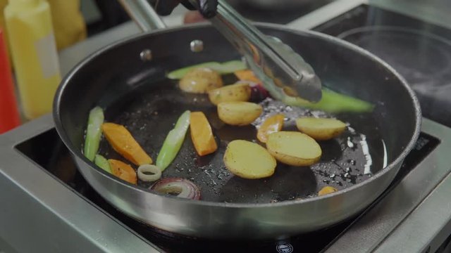 Frying ingredients on frying pan.