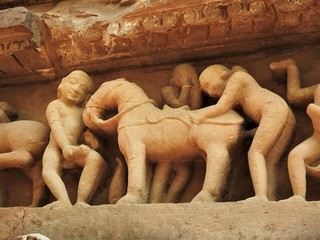 Sex poses from the kamasutra, erotic close - up of intricate carved scenes on the walls of Hindu temples in the Western group of Khajuraho, India