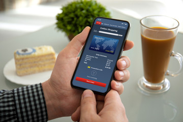male hands holding phone with app online shopping on screen