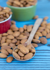 Almond nut on wood spoon.