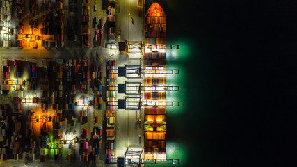 Container ship in export and import business logistics and transportation. Cargo and container box shipping to harbor by crane. Water transport International. Aerial view and top view.