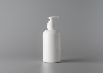 Blank white cosmetic bottle on grey background for print design and mock up
