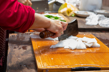 Traditional religious beliefs, devout believers prepare sacrifices, cut squid, squid