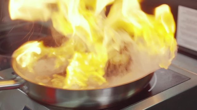 Professional cook in a restaurant making dish.