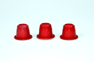 Collection of espresso coffee capsules red isolated on white background, Closeup view with details.