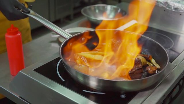 Pro Chef Making Flambe Style Dish.