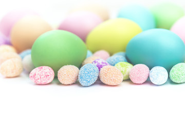 Colorful Assorted sizes Pastel Happy Easter Eggs sunny background with copy space